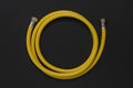 Yellow gas connection hose on a black background