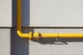 Yellow gas pipe in front of residential building wall Royalty Free Stock Photo