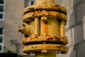 Yellow gas pipe with valve open close goes along the facade of a multi-storey building. Royalty Free Stock Photo