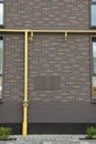 Yellow gas pipes near brick wall outdoors Royalty Free Stock Photo