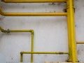 Yellow gas pipes on old dirty building wall Royalty Free Stock Photo