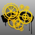 Yellow gear wheels of clockwork with black blot on gray