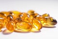 Yellow gel capsules, vitamin E, vitamin D, white background. Royalty Free Stock Photo