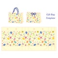 Yellow gift bag with baby accessories pattern