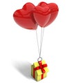 Yellow gift box lifted by three red balloons Royalty Free Stock Photo