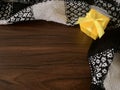 Yellow Gift box with scarf on wooden brown background. Royalty Free Stock Photo