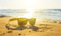 Yellow glasses the sea sand, sunglasses with beautiful sea scenery. sunglasses are reflected in the Golden wet sand as