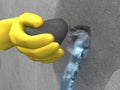 Yellow-gloved hand put extra-rapid cement in hole