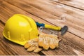 Yellow hard hat and leather work gloves, hammer Royalty Free Stock Photo