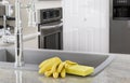 Yellow gloves and sponge in kitchen Royalty Free Stock Photo