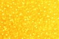 Yellow gold blurred bokeh sparkle shiny light glitter background.  Concept for New Year, Christmas and All Celebrations. Royalty Free Stock Photo