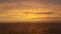 Yellow gold clouds on all sky during a sunset.