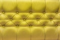 Yellow or gold leather upholstery sofa with pattern button design furniture style decor texture background Royalty Free Stock Photo