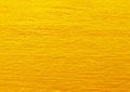 Yellow golden cement wall texture for background