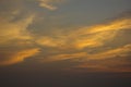 Yellow golden clouds in the evening dark blue sunset sky Royalty Free Stock Photo