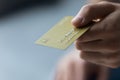 Yellow golden credit card in human hand close up Royalty Free Stock Photo