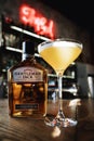 Yellow gourmet cocktail with gentleman jack whiskey on the bar