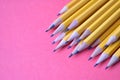 Yellow graphite pencils on a pink background Royalty Free Stock Photo