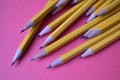 Yellow graphite pencils on a pink background Royalty Free Stock Photo