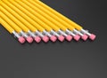 Yellow graphite pencils in a row on a dark background Royalty Free Stock Photo