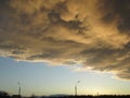 Yellow gray storm clouds. Cumulonimbus dramatic sky wave formation over the city. Weather after the thunderstorm, light Royalty Free Stock Photo