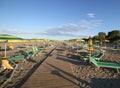 Yellow and green beach chairs and umbrellas on a beach Royalty Free Stock Photo