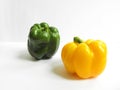 Yellow and green bell peppers on a white background. Fresh and shiny bell peppers