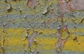 Yellow green blue plastered old painted concrete wall with  peeling paint Royalty Free Stock Photo