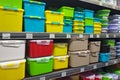 Yellow, green, blue plastic containers on store shelves.