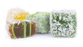 Yellow, green and brown Turkish Delight in coconut chips isolated on white background Royalty Free Stock Photo
