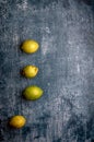 yellow and green lemons, cut and uncut, on a blue, dark, metallic, cement, marble, stone background Royalty Free Stock Photo