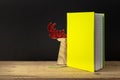 a yellow green note book with hidden reindeer on a wooden table Royalty Free Stock Photo