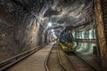 Yellow and green passenger train in a mine Royalty Free Stock Photo