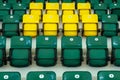 Yellow and green plastic seats in the stands of the sports complex. Auditorium for sports fans. Seats for spectators of a football Royalty Free Stock Photo