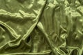 yellow-green satin fabrics lying on the ground with some water