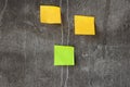 Yellow and green sticky notes on the gray wall Royalty Free Stock Photo