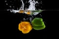 Yellow And Green Sweet Pepper Splash Into A Black Color