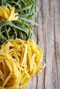 Yellow and green uncooked pasta tagliatelle Royalty Free Stock Photo