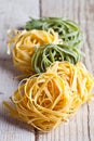 Yellow and green uncooked pasta tagliatelle Royalty Free Stock Photo