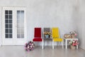 yellow grey red chairs with flowers in bright room Royalty Free Stock Photo