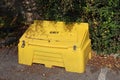 A yellow grit bin in a public car park in readiness for winter driving conditions Royalty Free Stock Photo