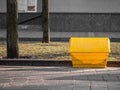 A yellow grit salt box on the street. Royalty Free Stock Photo