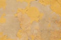 Yellow grunge abstract background texture. Old cement wall with yellow cracked paint Royalty Free Stock Photo