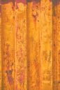 Yellow grunge sea freight container background, dark rusty corrugated pattern, red primer coating, vertical rusted detailed steel