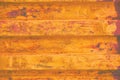 Yellow grunge sea freight container background, dark rusty corrugated pattern, red primer coating horizontal rusted detailed steel