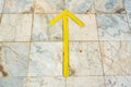 Yellow guide arrow on marble floor Royalty Free Stock Photo