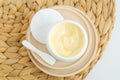 Yellow hair mask (banana face cream, shea butter mask, mango body butter) in a small white container. Natural skin care Royalty Free Stock Photo