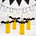 Yellow Halloween beverages for kids party on white table