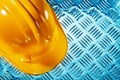 Yellow halmet on corrugated metallic sheet