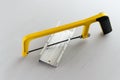 Yellow hand saw and aluminium miter box for hobby in home workshop Royalty Free Stock Photo